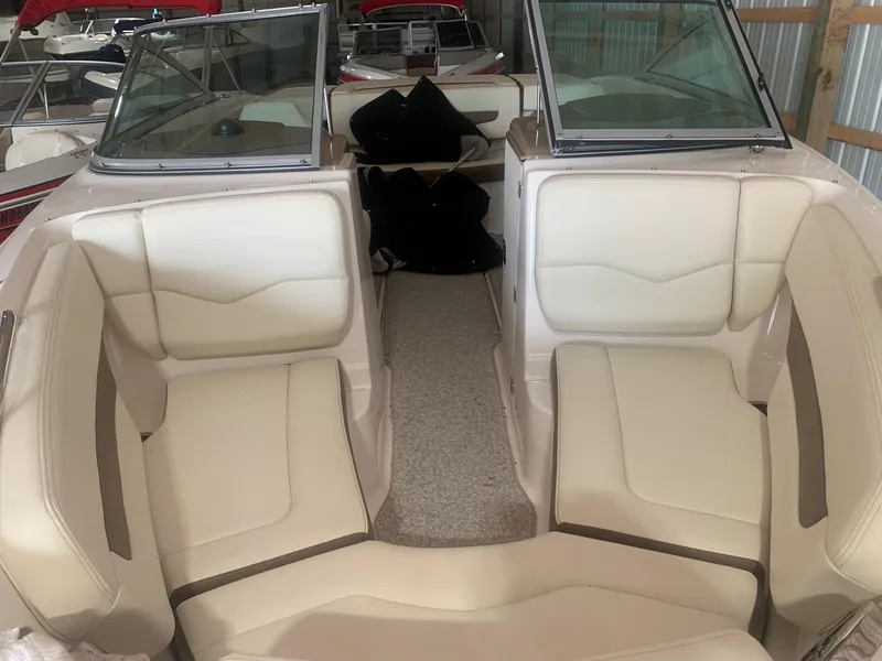 Slide: The Image of 2013 Chaparral 206 SSi boat interior with beige seating and open bow layout. - 6