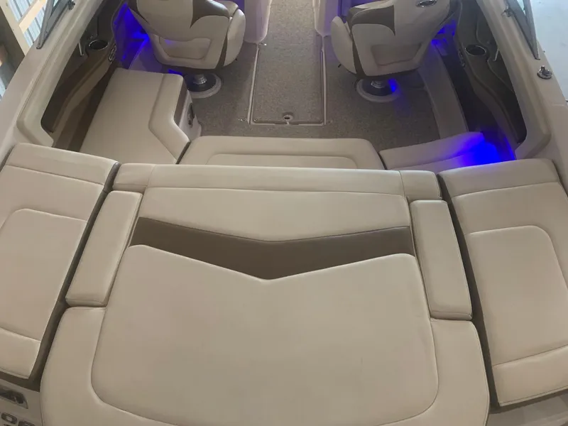 Slide: The Image of Interior of 2013 Chaparral 206 SSi boat with beige seating and blue accent lighting. - 7