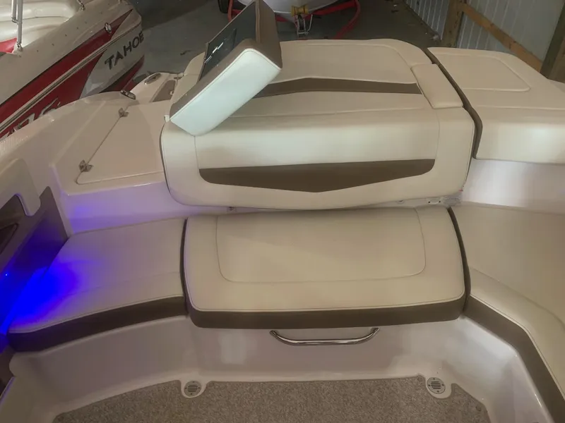 Slide: The Image of 2013 Chaparral 206 SSi boat interior with beige and brown seating. - 8