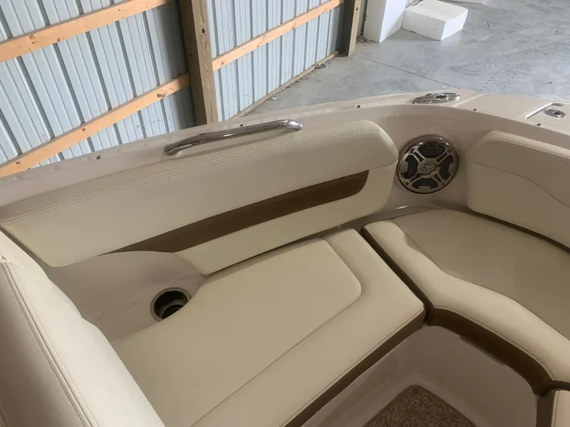 Slide: The Image of 2013 Chaparral 206 SSi boat interior with beige seating and speaker. - 9