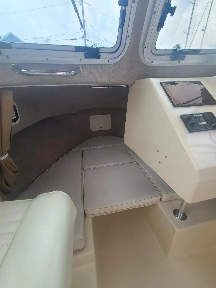 Slide: The Image of 2011 Parker 2120 Sport Cabin interior with seating and control panel. - 11