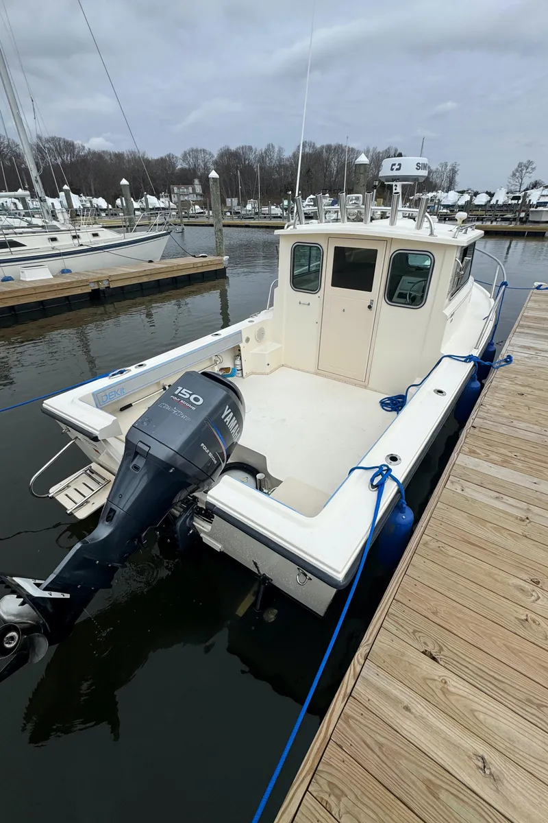Slide: The Image of 2011 Parker 2120 Sport Cabin boat docked with Yamaha outboard motor. - 3