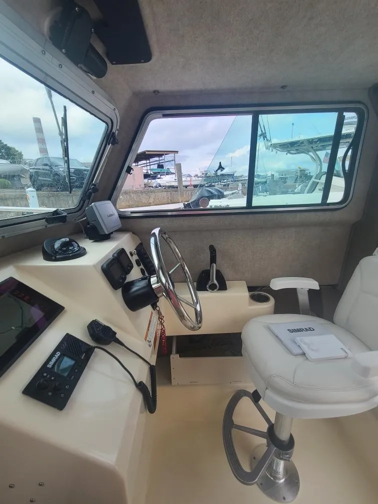 Slide: The Image of 2011 Parker 2120 Sport Cabin interior with steering wheel and navigation equipment. - 5