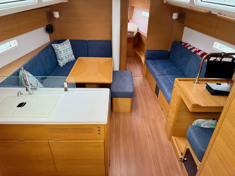 Slide: The Image of Interior of 2019 X-Yachts X4⁶ sailboat with modern wood finish and blue seating. - 13