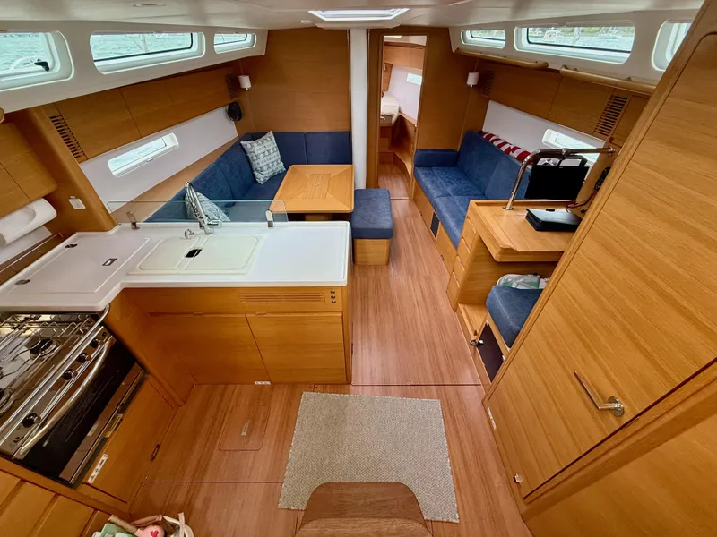 Slide: The Image of Luxurious interior of 2019 X-Yachts X4⁶ sailboat with modern kitchen and seating area. - 14