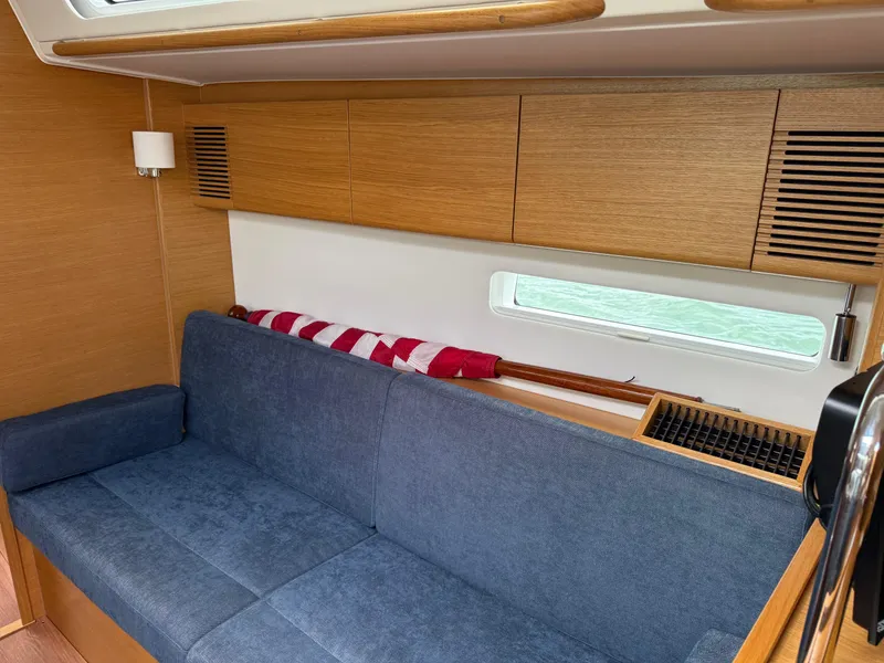 Slide: The Image of Interior of 2019 X-Yachts X4⁶ with blue sofa and wooden cabinetry. - 16