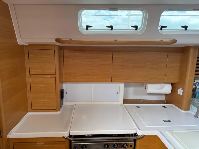 Slide: The Image of 2019 X-Yachts X4⁶ yacht kitchen with wooden cabinets and modern appliances. - 17