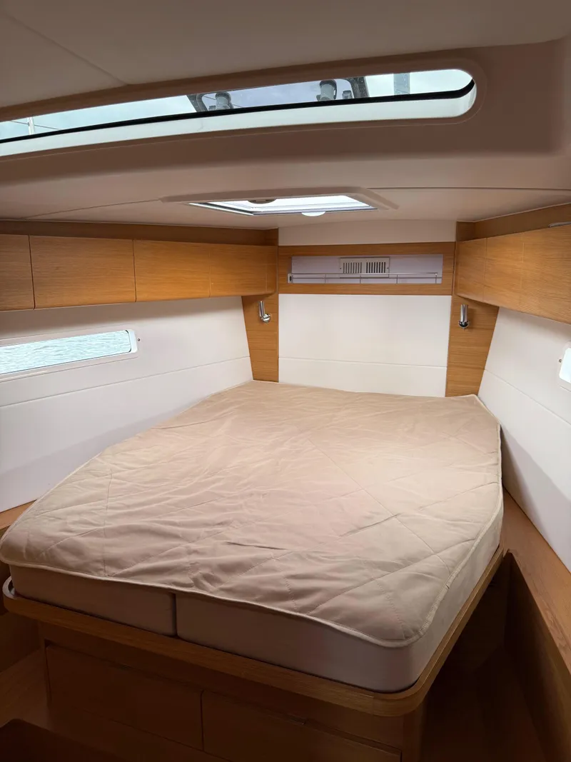 Slide: The Image of 2019 X-Yachts X4⁶ cabin interior with cozy bed and wooden accents. - 19