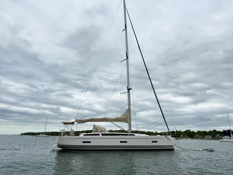 Slide: The Image of 2019 X-Yachts X4⁶ sailboat on calm water under cloudy sky. - 2