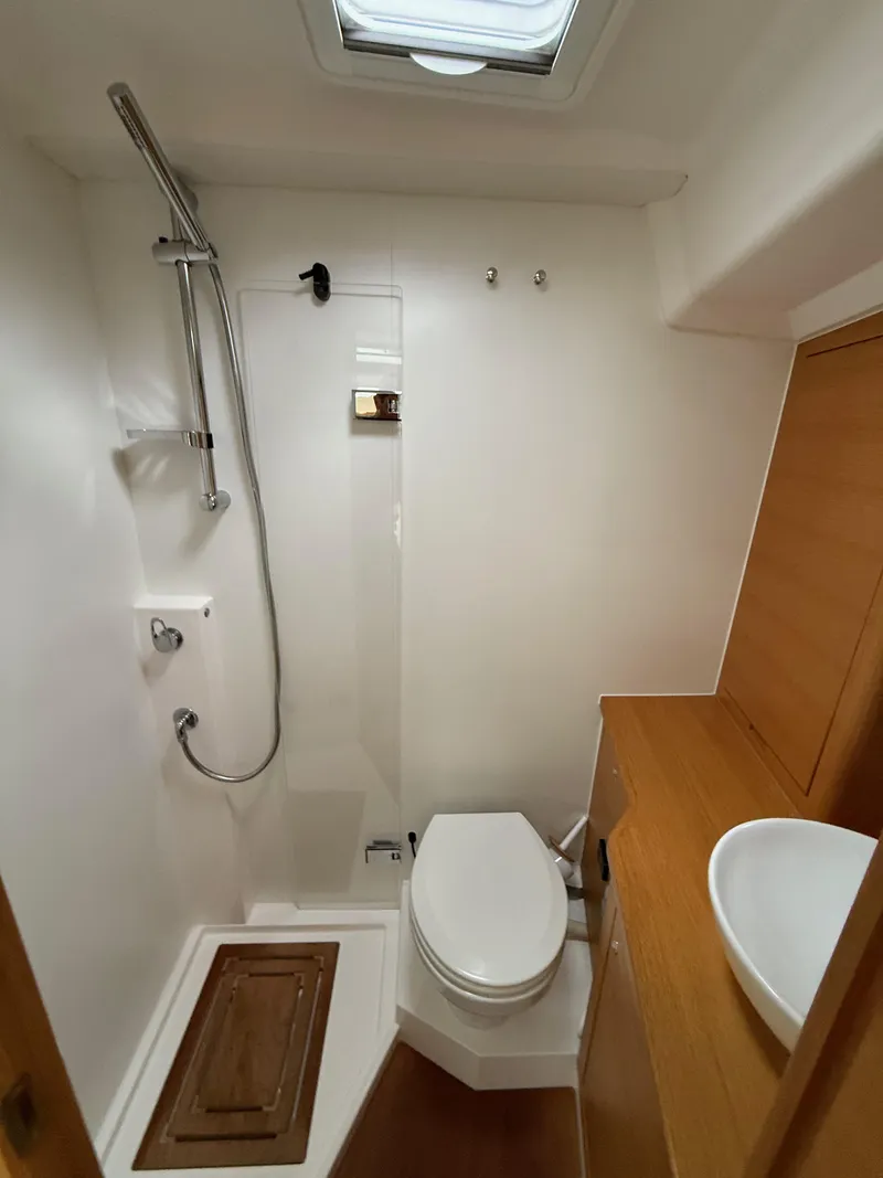 Slide: The Image of 2019 X-Yachts X4⁶ bathroom with shower, toilet, and wooden cabinetry. - 21