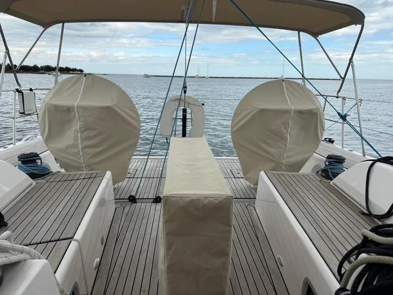 Slide: The Image of 2019 X-Yachts X4⁶ sailboat deck with covered equipment, ocean view, and clear sky. - 7