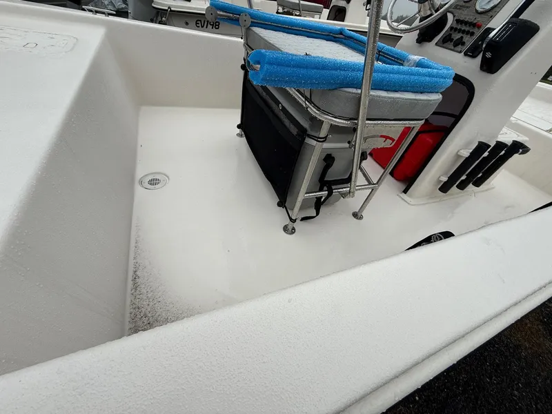 Slide: The Image of 2025 Carolina Skiff E18 JVX CC boat interior with seating and console. - 2