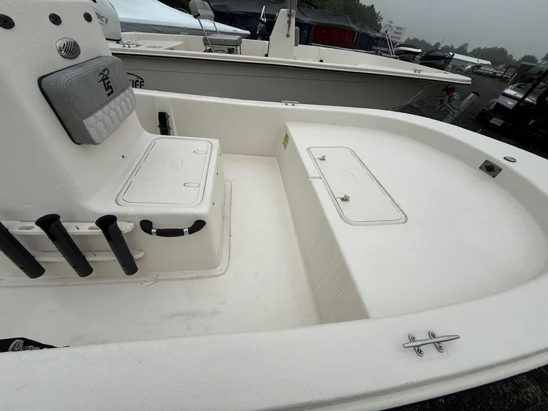 Slide: The Image of 2025 Carolina Skiff E18 JVX CC boat interior with seating and storage compartments. - 3