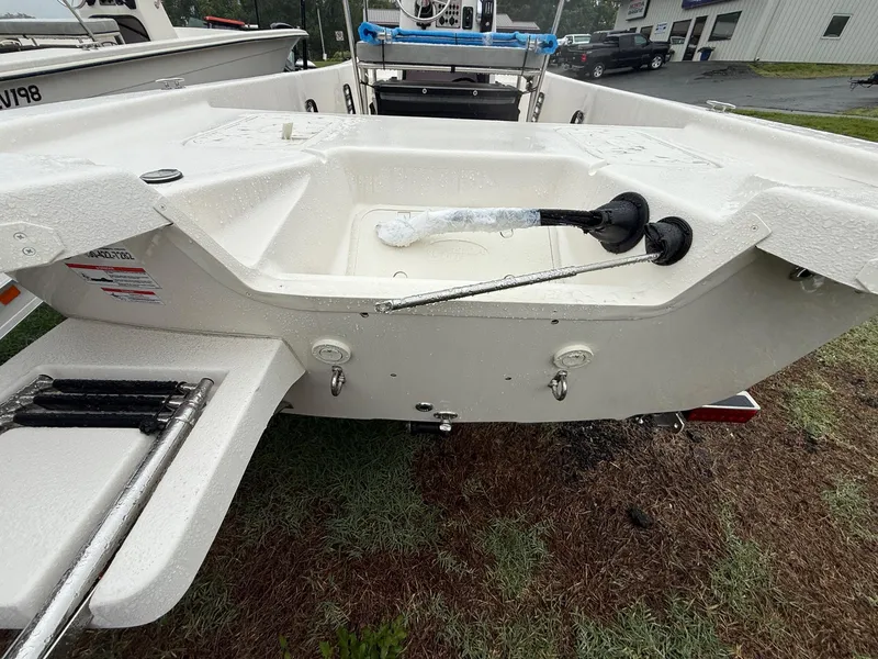 Slide: The Image of 2025 Carolina Skiff E18 JVX CC boat stern view with ladder and storage area. - 4