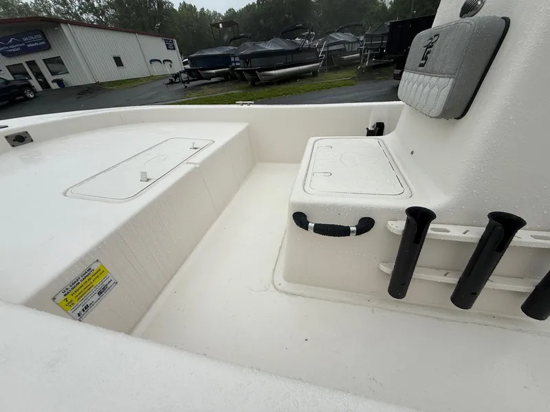 Slide: The Image of 2025 Carolina Skiff E18 JVX CC boat interior with seating and storage compartments. - 6