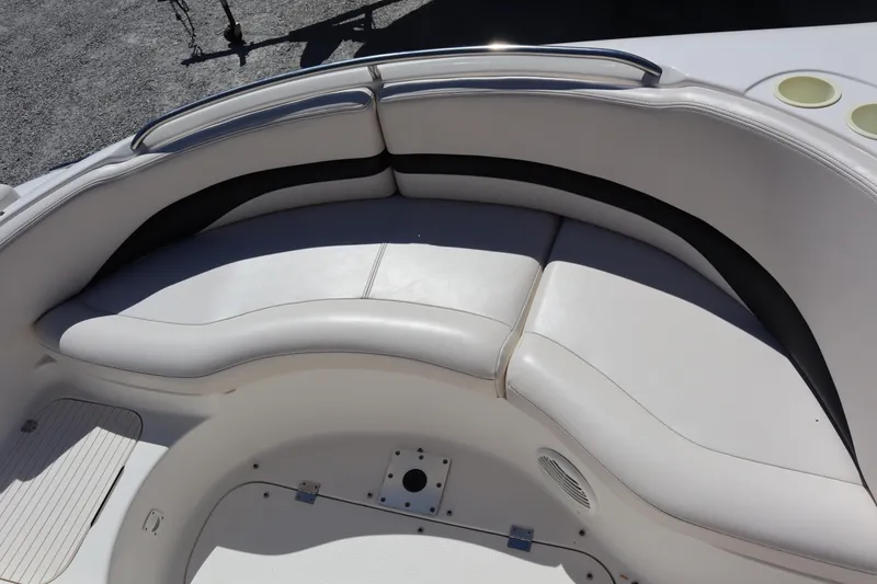 Slide: The Image of 2000 Chaparral Sunesta 232 boat interior with white cushioned seating. - 12