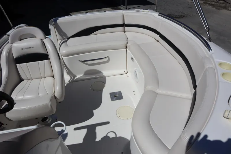 Slide: The Image of 2000 Chaparral Sunesta 232 boat interior with white seating and steering area. - 20