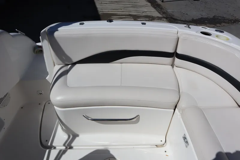 Slide: The Image of 2000 Chaparral Sunesta 232 boat seating area with white and black upholstery. - 24