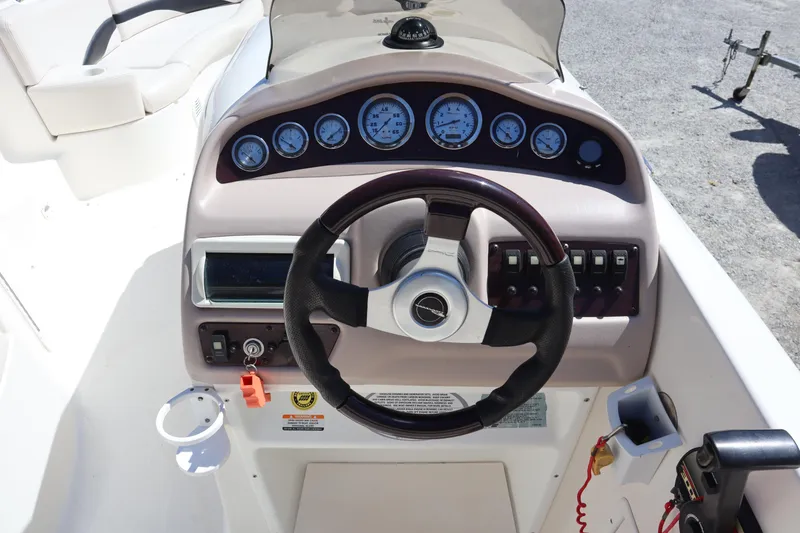 Slide: The Image of 2000 Chaparral Sunesta 232 boat dashboard with steering wheel and gauges. - 25