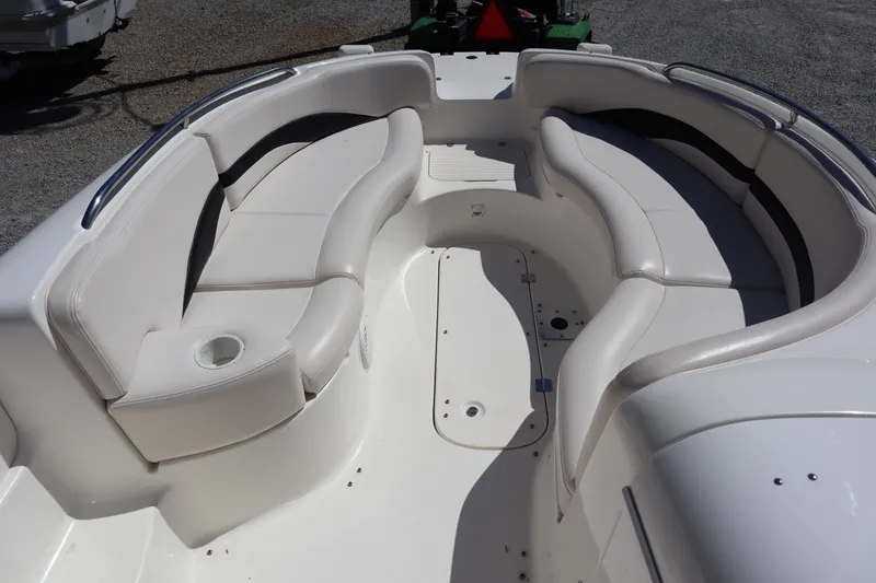 Slide: The Image of 2000 Chaparral Sunesta 232 boat interior with white seating and cup holder. - 7