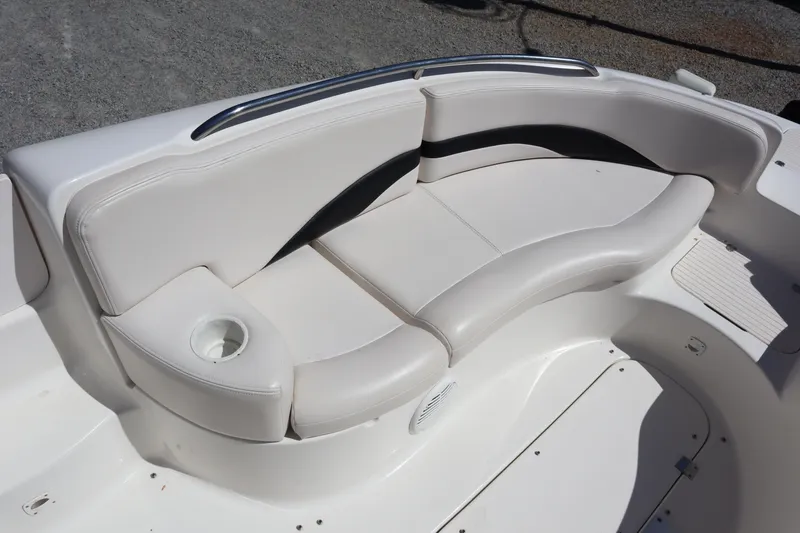 Slide: The Image of 2000 Chaparral Sunesta 232 boat seating area with white and black upholstery. - 8