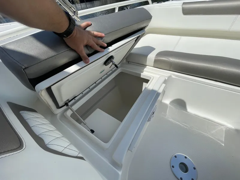 Slide: The Image of 2022 World Cat 255 DC boat storage compartment with cushioned seating. - 18