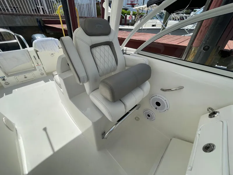 Slide: The Image of 2022 World Cat 255 DC boat interior with cushioned seating and modern design. - 27