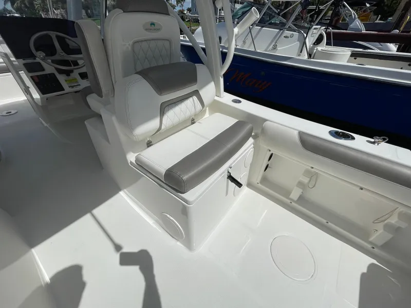 Slide: The Image of 2022 World Cat 255 DC boat interior with cushioned seating and storage compartments. - 28