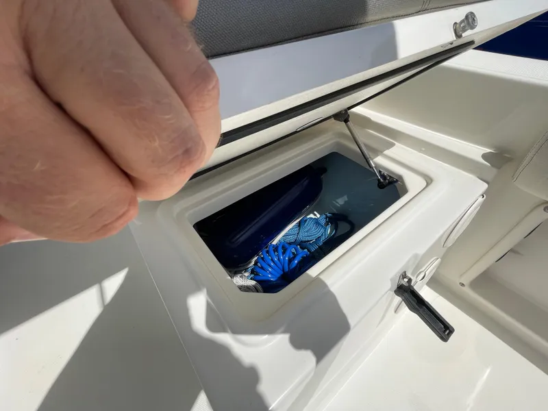 Slide: The Image of 2022 World Cat 255 DC storage compartment with blue rope inside. - 29