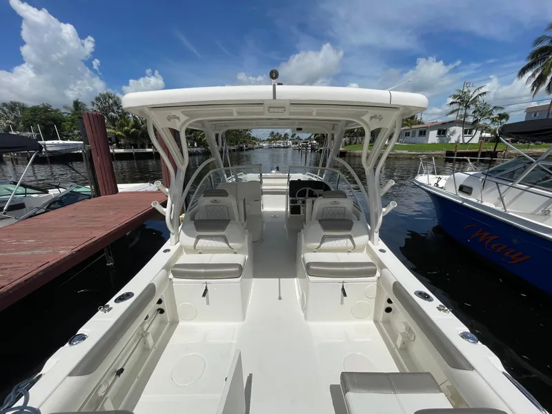 Slide: The Image of 2022 World Cat 255 DC boat docked, showcasing spacious seating and sleek design. - 38