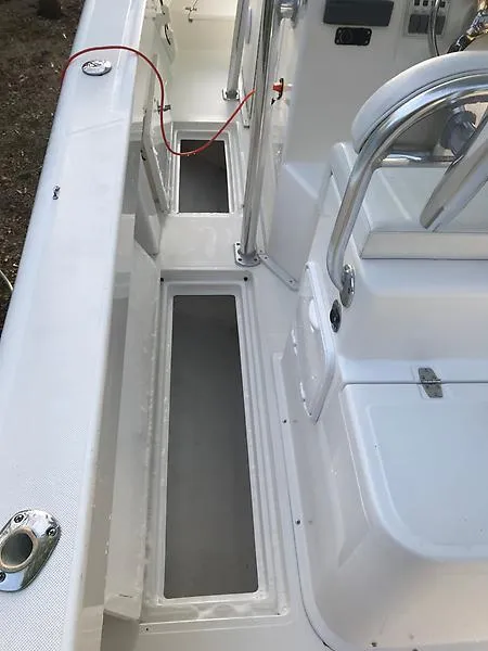 Slide: The Image of 2014 Ocean Master 29 CC boat interior with seating and storage compartments. - 11