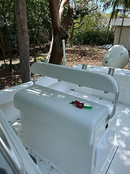 Slide: The Image of 2014 Ocean Master 29 CC boat interior with seating and trees in the background. - 12