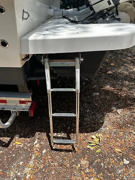 Slide: The Image of 2014 Ocean Master 29 CC boat with a foldable ladder on the stern. - 16