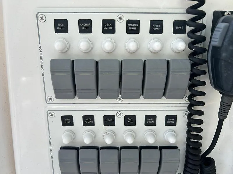 Slide: The Image of Control panel of a 2014 Ocean Master 29 CC boat with labeled switches and microphone. - 17