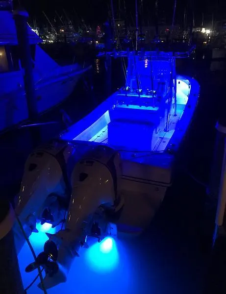 Slide: The Image of 2014 Ocean Master 29 CC boat with blue LED lights at night. - 4