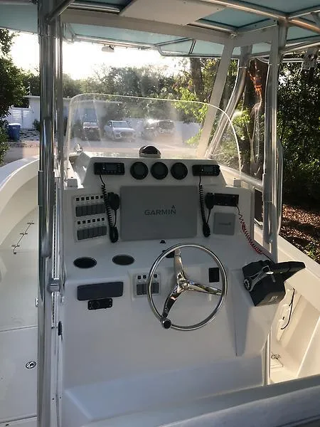 Slide: The Image of 2014 Ocean Master 29 CC boat cockpit with steering wheel and control panel. - 6