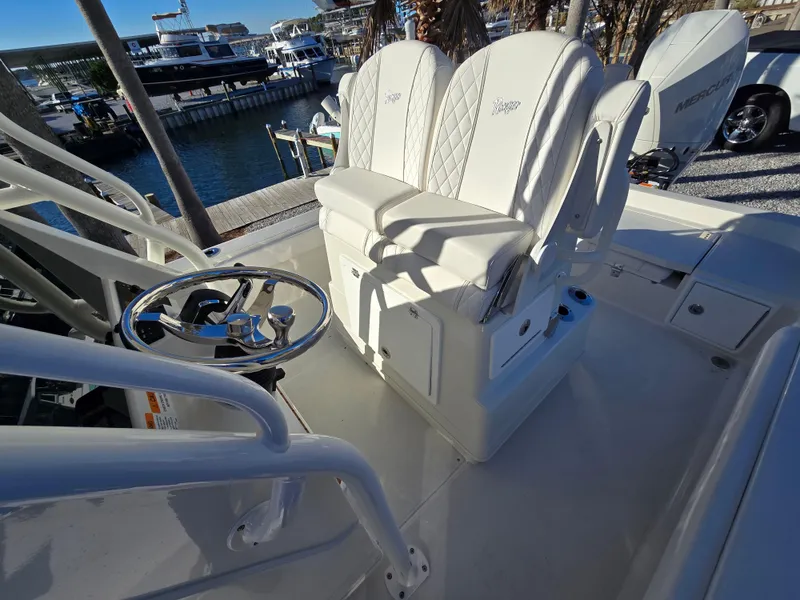 Slide: The Image of 2025 Ranger 2360 Bay boat interior with white seating and steering wheel. - 11