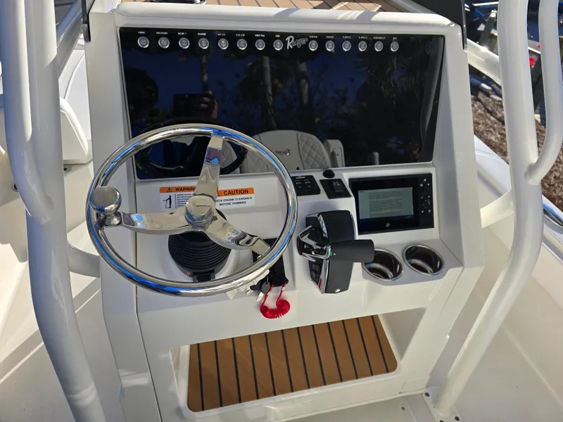Slide: The Image of Control panel of 2025 Ranger 2360 Bay boat with steering wheel and navigation system. - 12