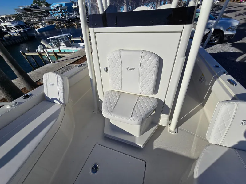 Slide: The Image of 2025 Ranger 2360 Bay boat interior with white cushioned seating. - 9