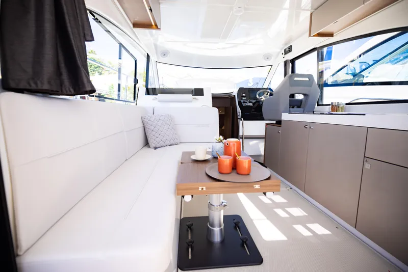 Slide: The Image of Interior of 2026 Beneteau Antares 11 yacht with modern seating and helm. - 11