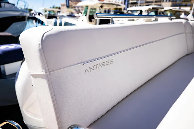 Slide: The Image of 2026 Beneteau Antares 11 boat seat with embossed logo, docked in marina. - 17