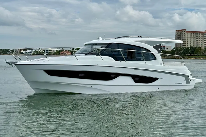 Slide: The Image of 2026 Beneteau Antares 11 yacht on calm water, showcasing sleek design and modern features. - 2