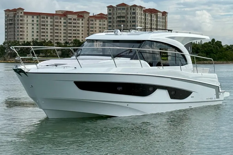 Slide: The Image of 2026 Beneteau Antares 11 yacht on water with buildings in background. - 4