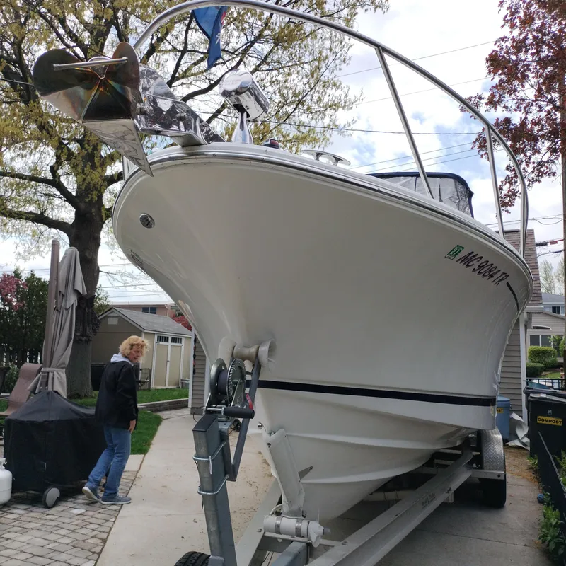 Slide: The Image of 2001 Chris-Craft 26 Constellation boat on trailer in residential driveway. - 1