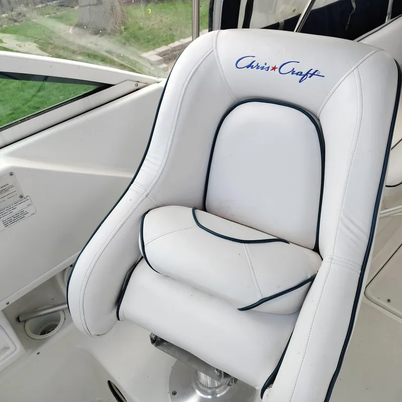 Slide: The Image of White captain's chair on 2001 Chris-Craft 26 Constellation boat, featuring logo embroidery. - 10