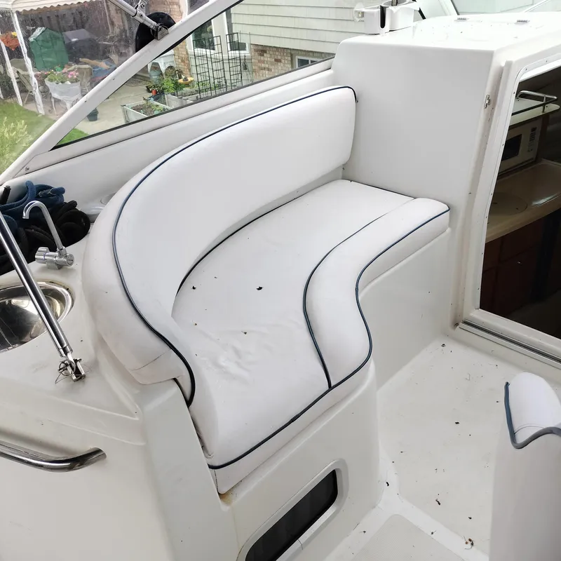 Slide: The Image of White seating area on 2001 Chris-Craft 26 Constellation boat, featuring sleek design and comfort. - 11