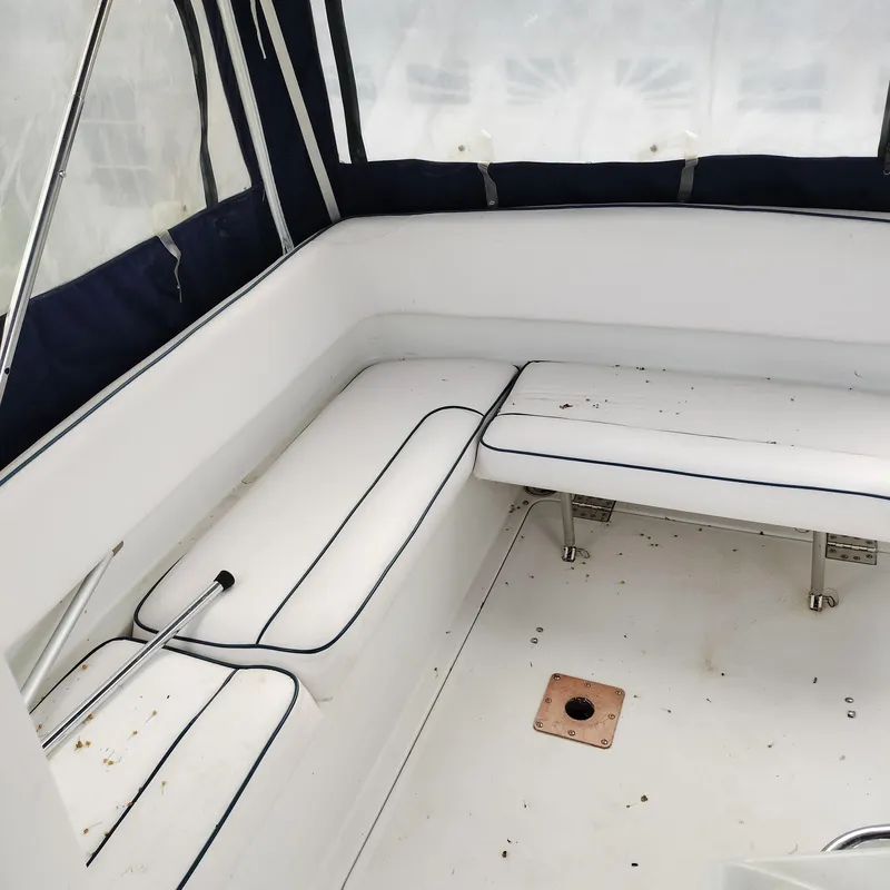 Slide: The Image of 2001 Chris-Craft 26 Constellation boat interior with white seating and navy trim. - 12