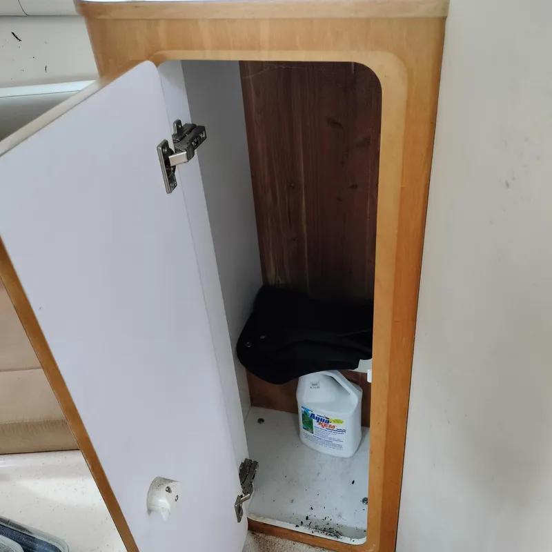 Slide: The Image of Open cabinet on Chris-Craft 26 Constellation 2001 boat, containing cleaning supplies. - 18