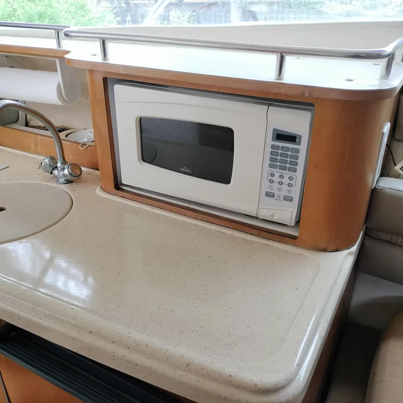 Slide: The Image of Kitchen area of 2001 Chris-Craft 26 Constellation with microwave and sink. - 20