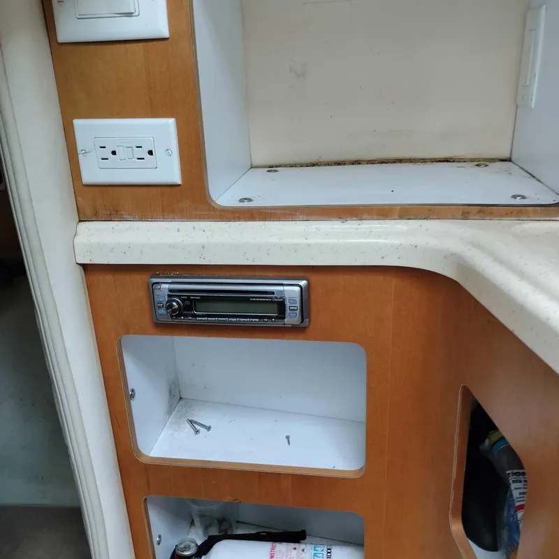 Slide: The Image of Interior of 2001 Chris-Craft 26 Constellation boat with wooden cabinetry and built-in stereo. - 22